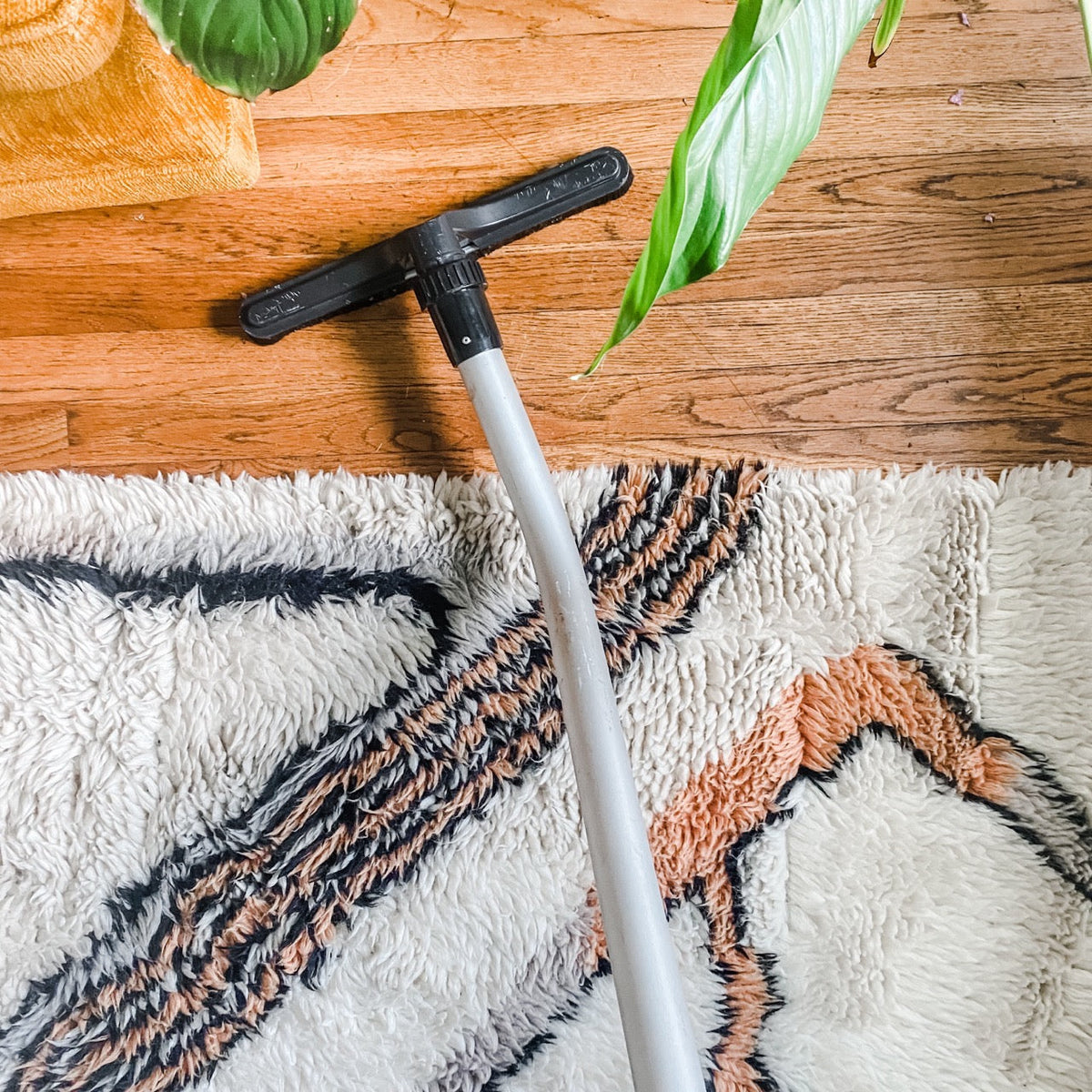vacuuming  wood floors with a hard floor vacuum